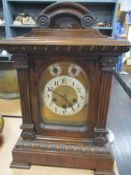 An early 20th century mahogany bracket clock, having beaded and carved detailing.
