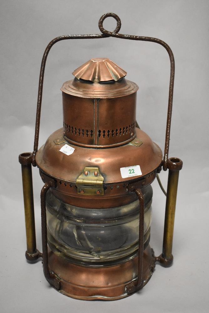 A 19th Century copper and brass ship's masthead lantern, with painted turned carrying handle, and