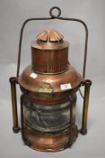 A 19th Century copper and brass ship's masthead lantern, with painted turned carrying handle, and
