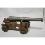 A vintage ornamental cannon, with embossed metal barrel, 42cm long