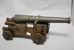 A vintage ornamental cannon, with embossed metal barrel, 42cm long