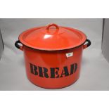 A vintage red enamel bread bin.
