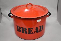 A vintage red enamel bread bin.