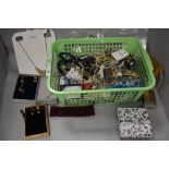A basket of costume jewellery, pearl style necklaces, earrings, and other jewellery