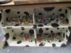 A bookcase containing the complete collection of Disneys 101 Dalmations toys, McDonald collection.