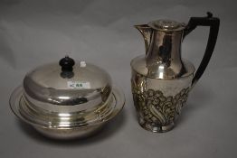 A silver plated coffee pot and a serving dish.