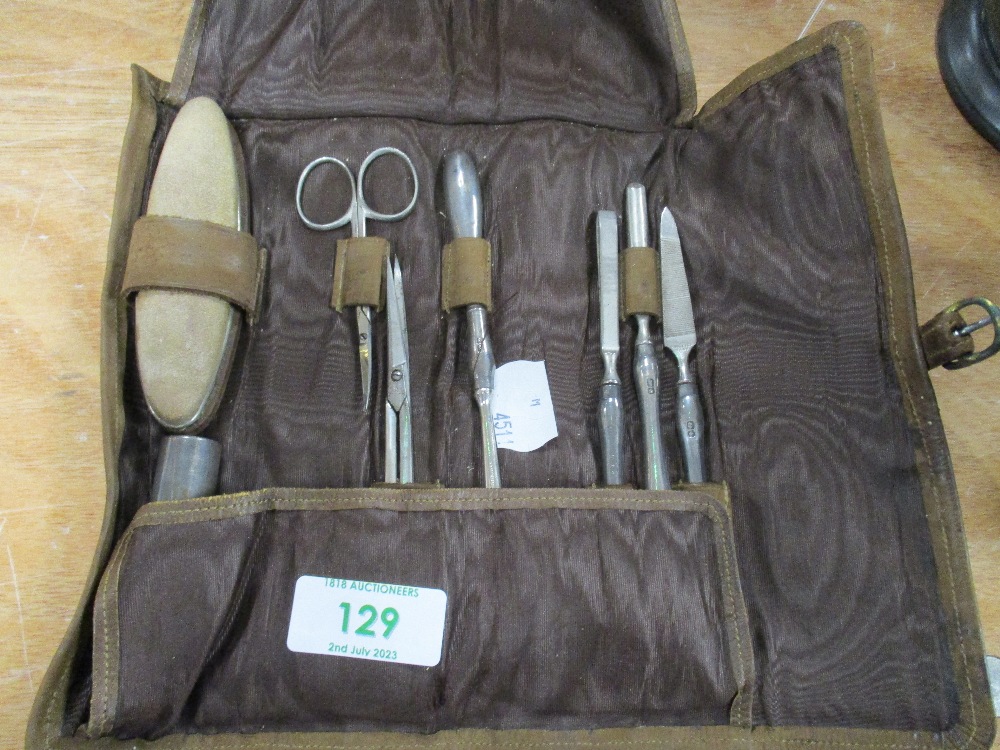 An early 20th century Hallmarked silver manicure set, in folding leather case.