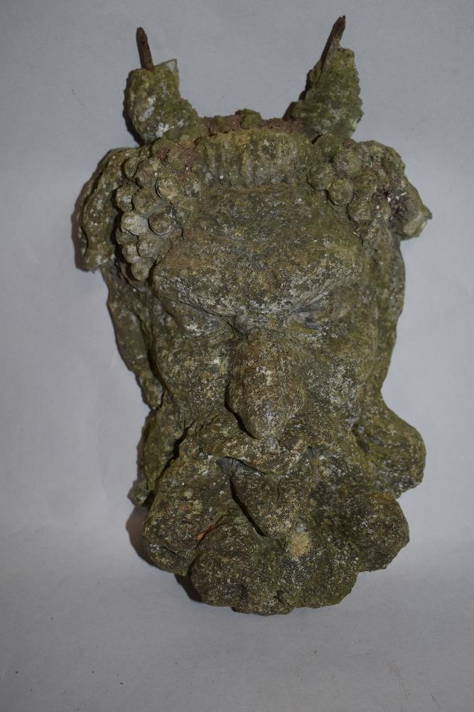 A concrete Bacchus mask, measuring 36cm long