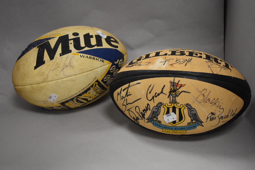 Two vintage rugby balls, one illustrated with the Newcastle Rugby Club crest, both with signatures