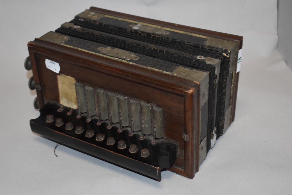 A 19th Century square concertina accordion, bearing a faded paper manufacturer's label, 26cm wide - Image 2 of 2
