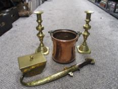 Two brass candlesticks, a hammered brass trinket dish, a copper and brass handled cooking pot and