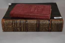 Two antique books, 'Every woman her own doctor' and 'Live stock in health and disease'.