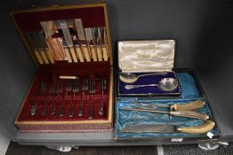 A vintage partial canteen of cutlery, including bone handled knives, some still with original
