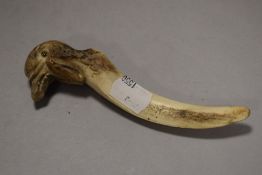 An antique horn letter opener, having carved bird handle, AF.
