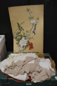 A collection of vintage table linen, including embroidered and deep crochet edged table cloths and