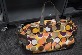 A retro style Roxy holdall, having wheels and handle, in good order.