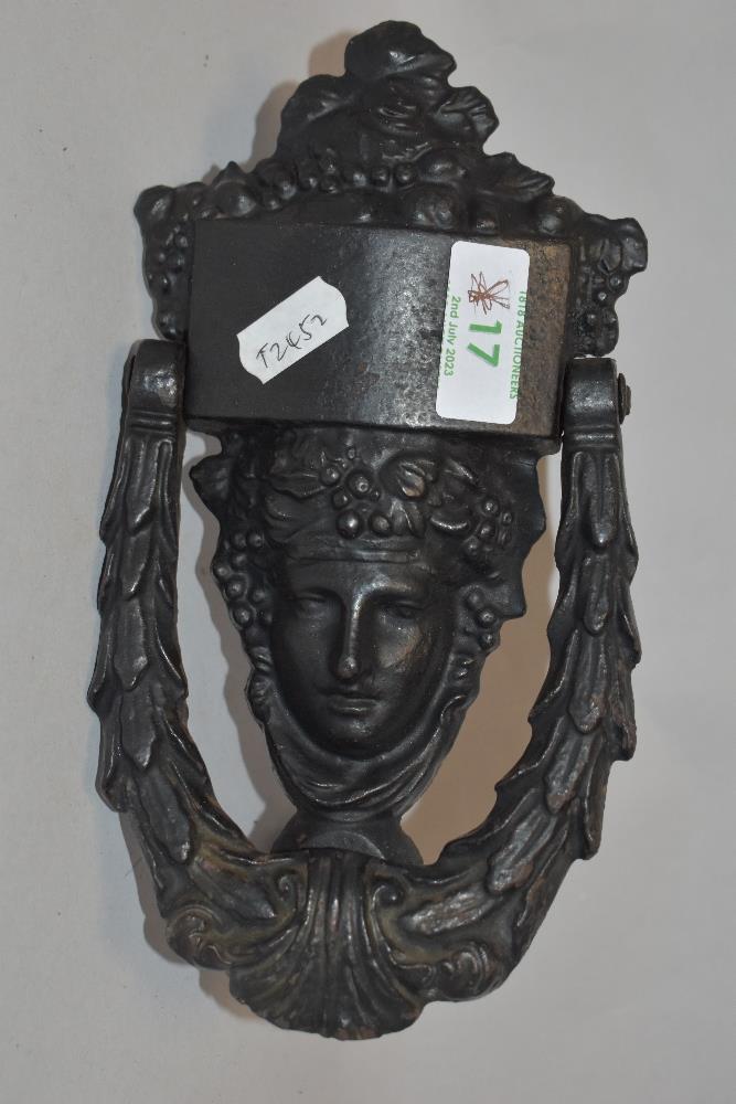 A George III Neo-Classical design cast-iron door knocker of Dionysus design, the Greek god of wine