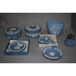 An assortment of blue and white Wedgwood Jasperware, including large trinket boxes, desk top lighter