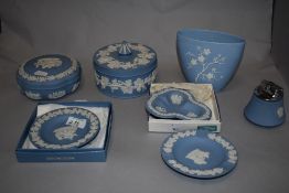 An assortment of blue and white Wedgwood Jasperware, including large trinket boxes, desk top lighter