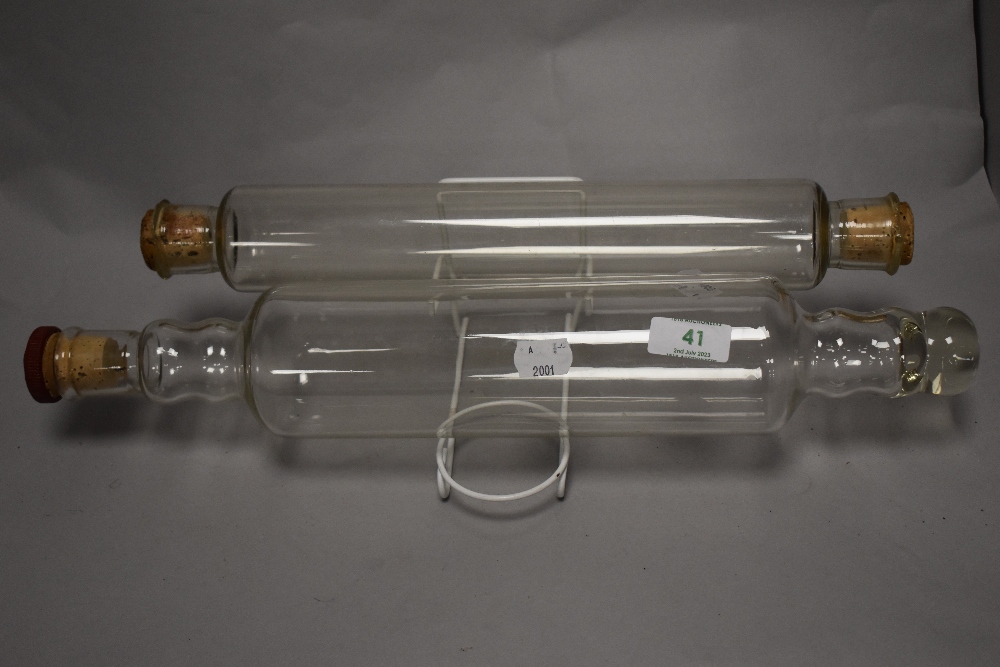 A 1950s Pyrex glass rolling pin and another, the former measuring 44cm long