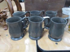 Six antique pewter tankards, each with impressed marks, some monogrammed.