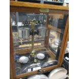 An early to mid 20th century wood and glass cased set of scientific scales.