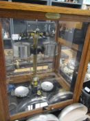 An early to mid 20th century wood and glass cased set of scientific scales.