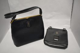 Two vintage leather handbags, both monogrammed with 'M', one 1950s black clutch bag with unusual