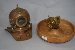 A novelty brass nutcracker, in the form of a ship's wheel, with attached turned wood bowl, 22cm in