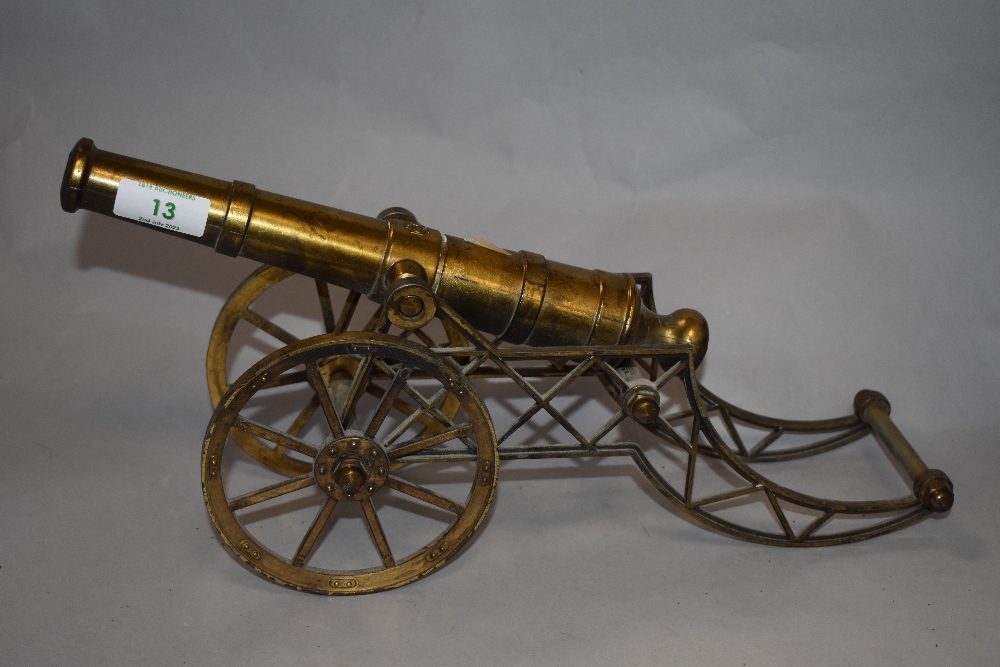 A vintage brass ornamental field gun, embossed AGAD to the barrel, 34cm long