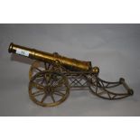 A vintage brass ornamental field gun, embossed AGAD to the barrel, 34cm long