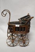 An antique style wood and metal dolls pram.