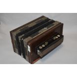 A 19th Century square concertina accordion, bearing a faded paper manufacturer's label, 26cm wide