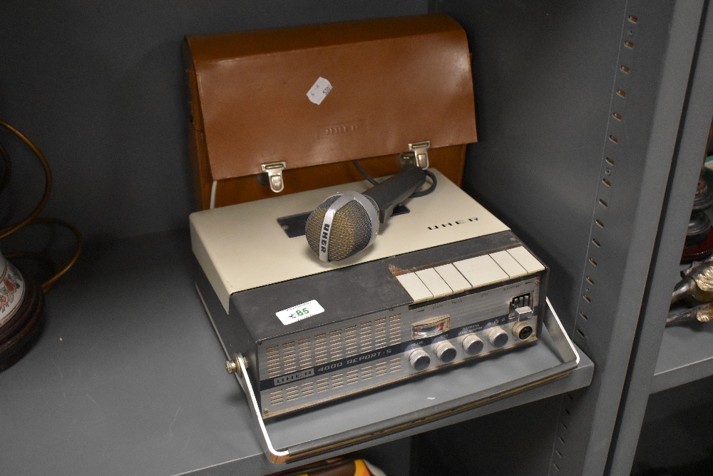 A vintage UHER portable reel to reel and microphone.