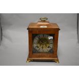 An early 20th Century bracket clock, having a two train movement, and housed within a walnut case