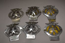 Six vintage AA membership car badges.