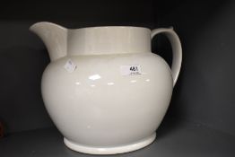 An over large white ceramic jug.