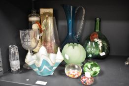 An assorted lot of glass, including Millefiori paperweights, vintage wine bottle, 1960s handkerchief