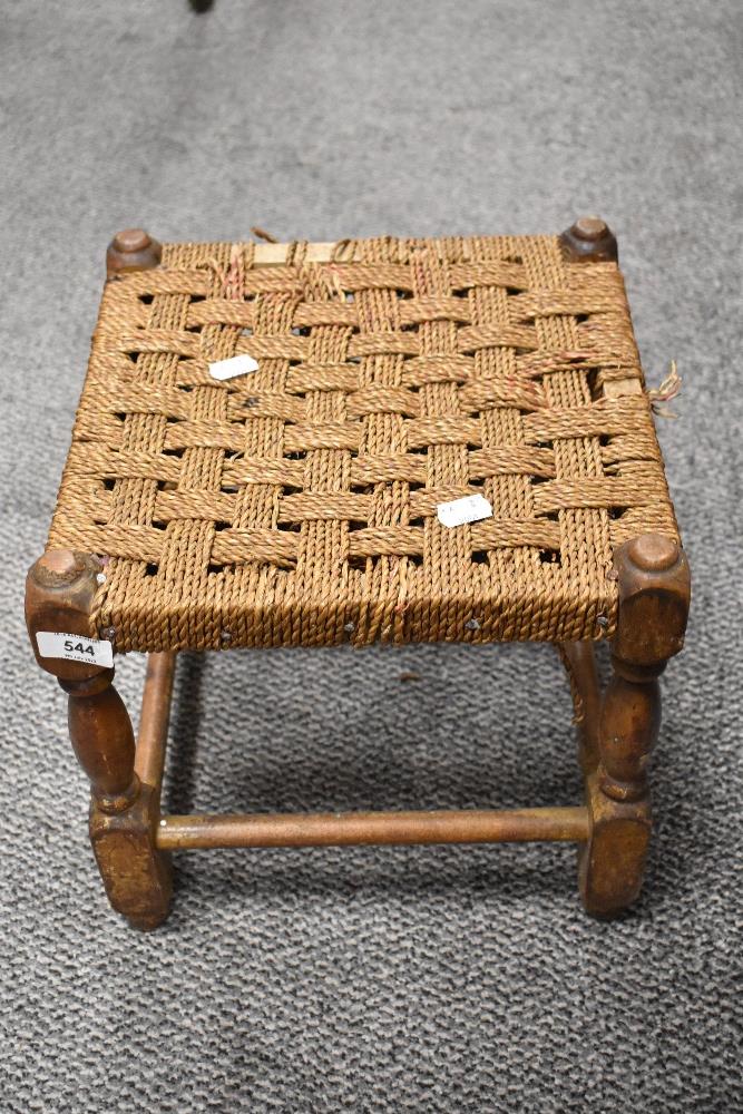 A small woven seated stool (AF).