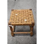 A small woven seated stool (AF).