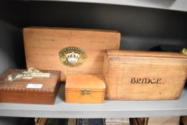 Four novelty and other wooden boxes, to include a version decorated with a flinklock pistol