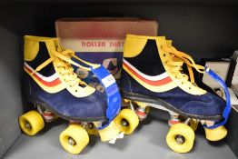 A pair of children's vintage roller skates, marked 6 to base, with their original box