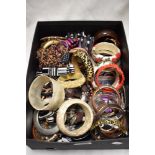 A box of mixed costume jewellery, including some vintage bangles.