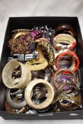 A box of mixed costume jewellery, including some vintage bangles.