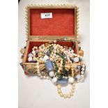 A shell encrusted jewellery box containing various jewellery, to include synthetic pearls, and other
