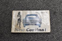 A Ford Cortina service book and an owner manual