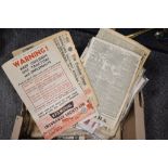 A box of vintage ephemera, including adverts, newspapers and magazines.