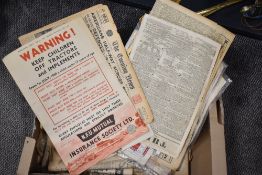 A box of vintage ephemera, including adverts, newspapers and magazines.