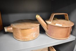 A copper stove top kettle with brass screw covers, sold together with a similar warming pan, both