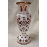 A 19th century Bohemian overlay glass vase, wheel-cut with apertures and painted with foliate